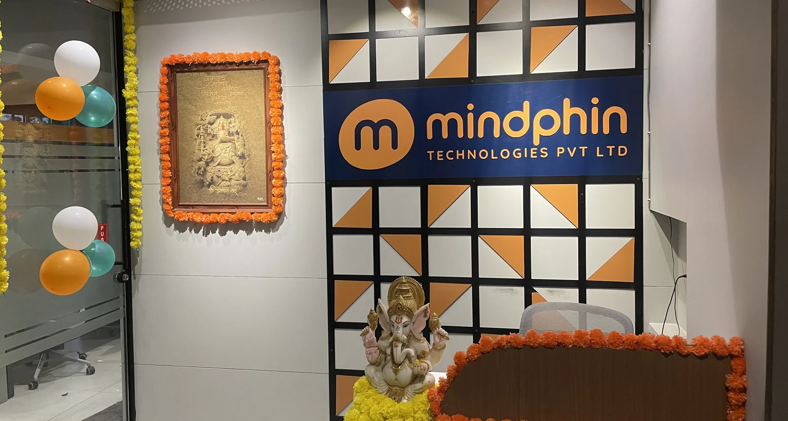 Mindphin office reception with the company logo wall and festive decorations